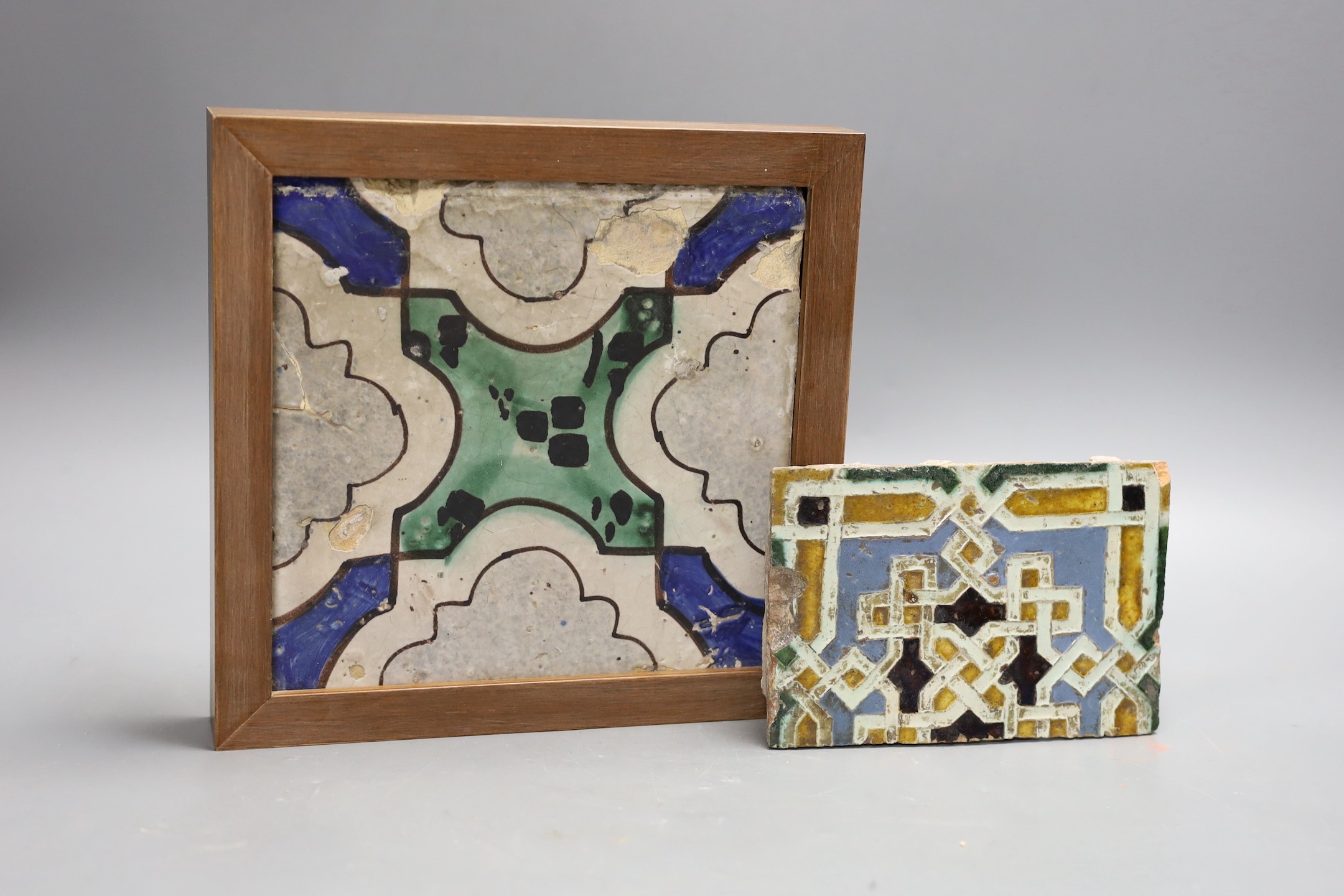 A Spanish tin-glazed earthenware floor tile, 16th/17th century and a larger tile, possibly Italian, largest 19cms